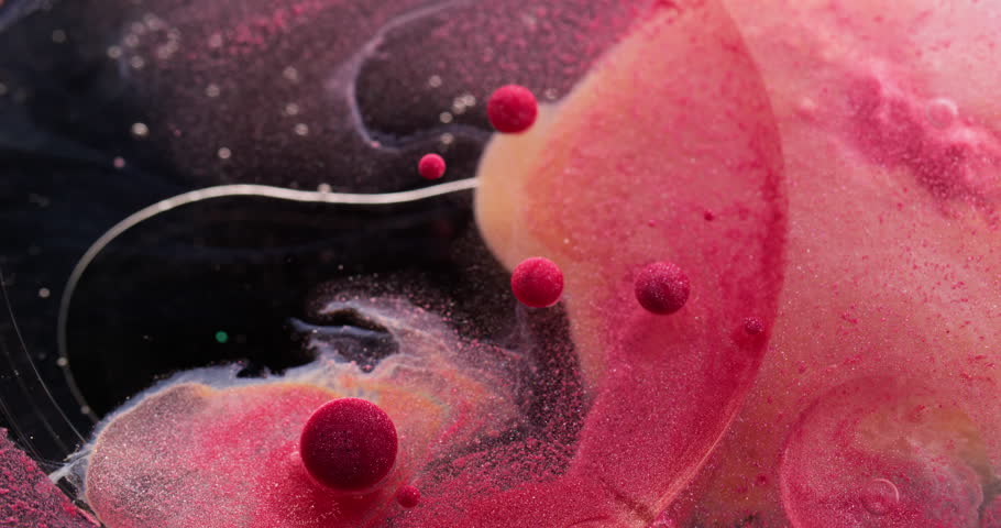 Dust fluid. Shimmering bubble. Colorful gel drops paint mix round pigment layer oil circle surface art pink balls dissolving black abstract background.
