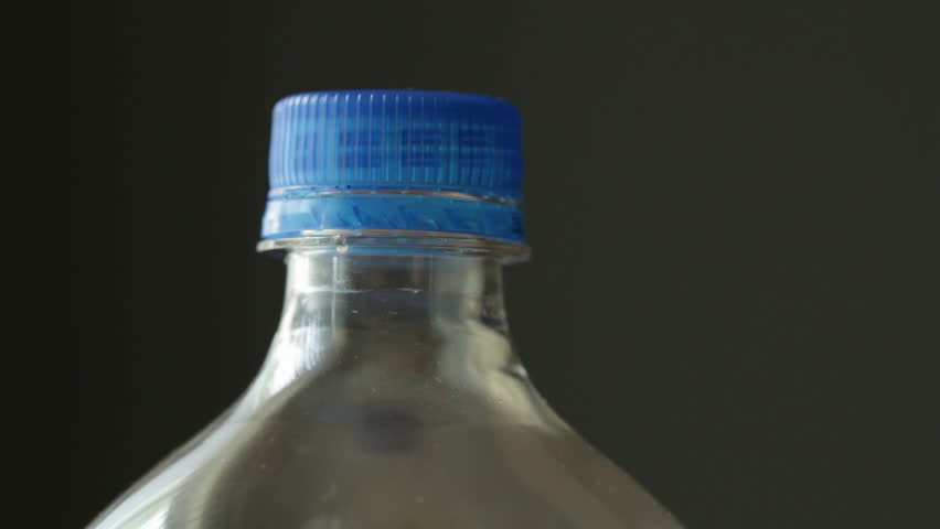 Unscrewing the top from a soda bottle. Overhead shhot with a macro lens and