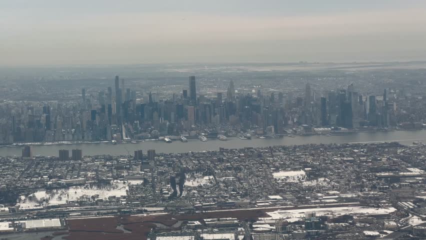 New York City winter skyline with Hudson River view from plane window