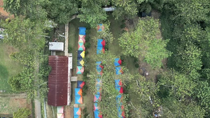 Aerial view, drone fly over nature mountain tourist sites, such as campsites, lodgings, swimming pools and open fields. Suitable for family, community and corporate recreational activities.