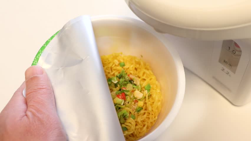 Pour hot water into the cup noodles