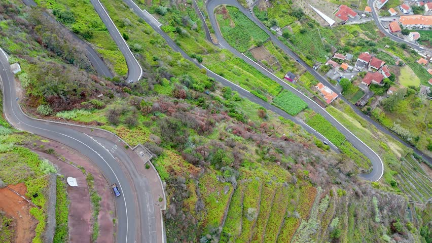 madeira island scenic mountains road path leading to porto Moniz travel destination in Portugal aerial top down