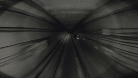 Underground train riding in darkness tunnel. Urban metro driving belowground. Subway train moving at dark tunnel. Point of view from the railway cabin. Transportation of people concept. Slow motion - Powered by Shutterstock - Get 15% off with code: PIKWIZARD15