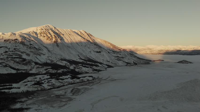 Sunlight Over Snow Mountain Peaks Near Silver City In Kluane National Park and Reserve, Yukon, Canada. Wide Shot
