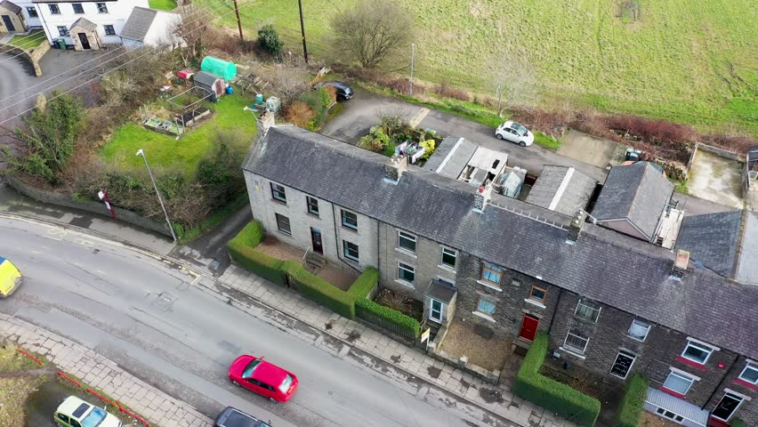Aerial footage of the town of Thornhill Edge
in Dewsbury West Yorkshire in the UK showing the British town from above and rows of traditional terrace houses from above in the winter time