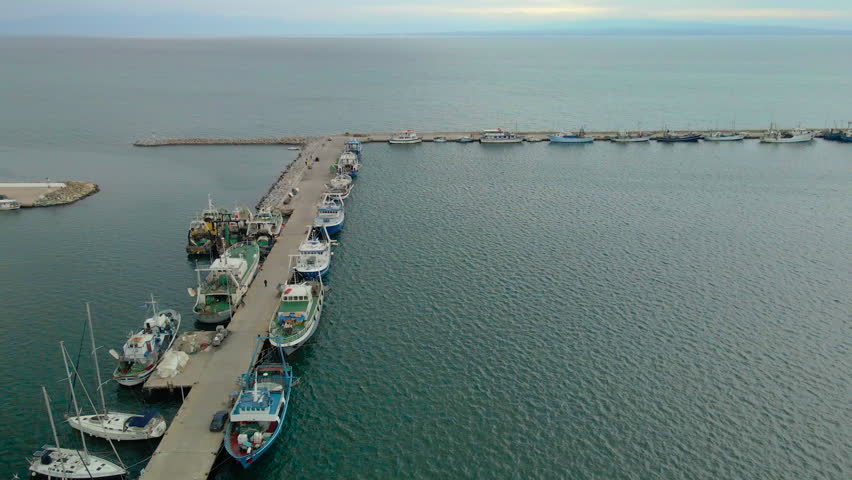 Fishing boats moored at the protected port of Nea Michaniona coastal town in Greece.