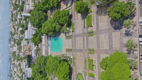Vertical aerial view of Eugenio María de Hostos Park in Santo Domingo, highlighting tree-lined paths and recreation areas by the Malecón. - Powered by Shutterstock - Get 15% off with code: PIKWIZARD15