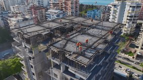 Aerial Video of a Construction Crew Working on Roofing, Concrete Pouring, and Installing Metal Beams - Powered by Shutterstock - Get 15% off with code: PIKWIZARD15