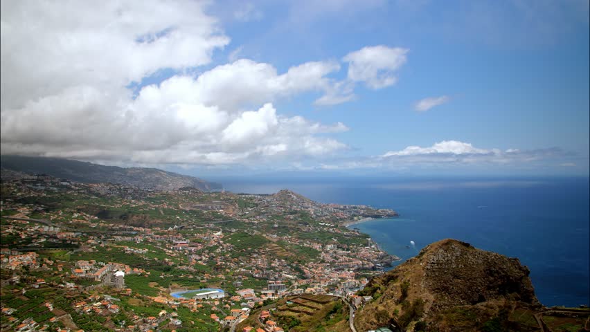 Time lapse of Madeira Funchal capital city with clouds moving faster from mountains view point cityscape