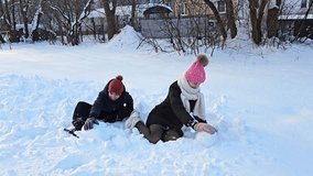 brother and sister playing with snow, fresh white snow on which children sit and make snowballs, childhood, winter in Europe, - Powered by Shutterstock - Get 15% off with code: PIKWIZARD15