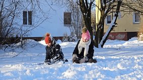 brother and sister playing with snow, fresh white snow on which children sit and make snowballs, childhood, winter in Europe, - Powered by Shutterstock - Get 15% off with code: PIKWIZARD15