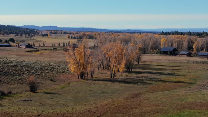 Serene aerial view of New Mexico’s fall landscape with distant mountains and open fields