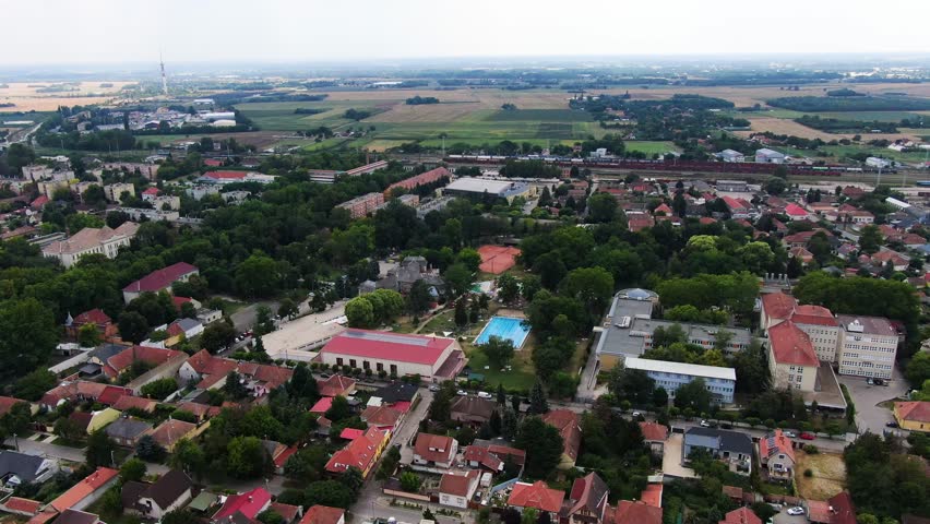 Lush green landscape with residential buildings, thermal beaches, and slides in Kiskunfelegyhaza, Hungary