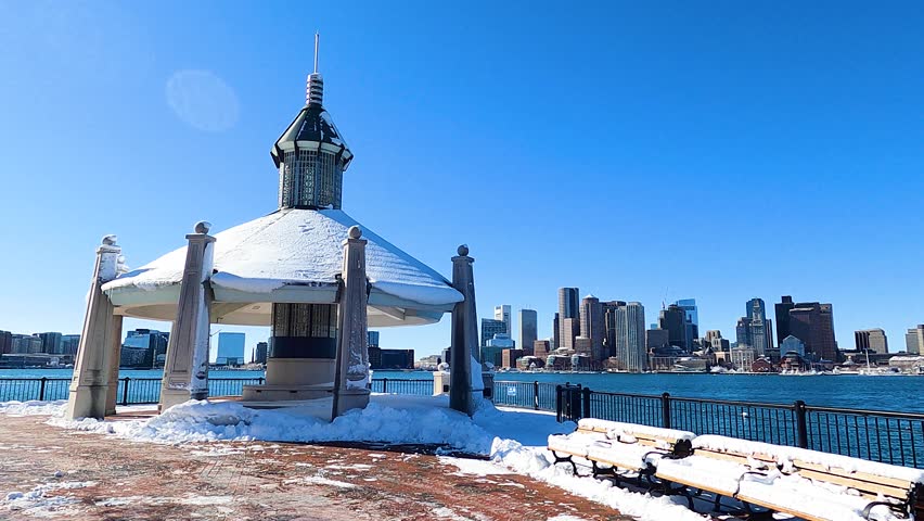 Time lapse of Pier Pavilion with Boston financial district skyline including historic Custom House and Boston Harbor from East Boston, Massachusetts MA, USA. 