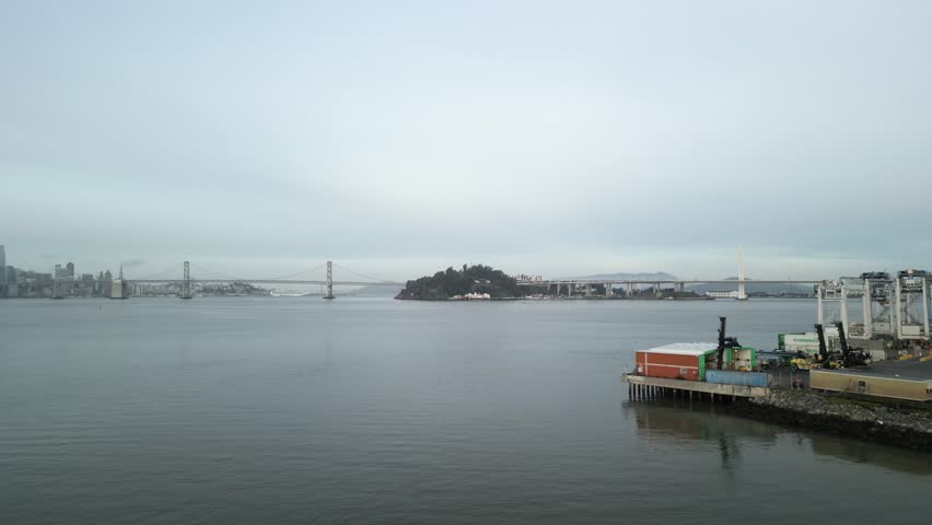 The San Francisco Bay Bridge appears in this distance, connecting San Francisco and Oakland in this aerial drone view.