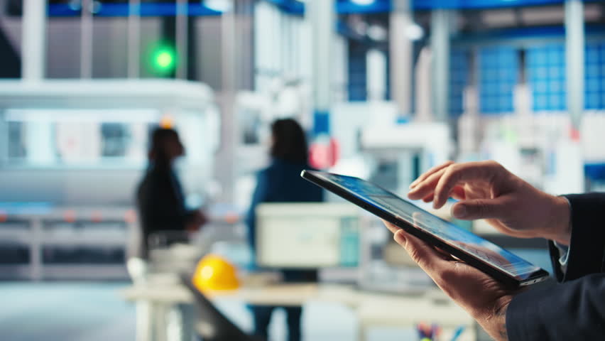 Engineer in photovoltaics factory using tracking software on tablet to diagnose malfunctioning systems. Solar panels manufacturing plant worker uses device to reduce downtime, camera A closeup