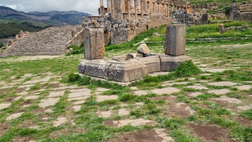 Revealing shot of Roman Severan temple ruins in Djemila Algeria on a cloudy day