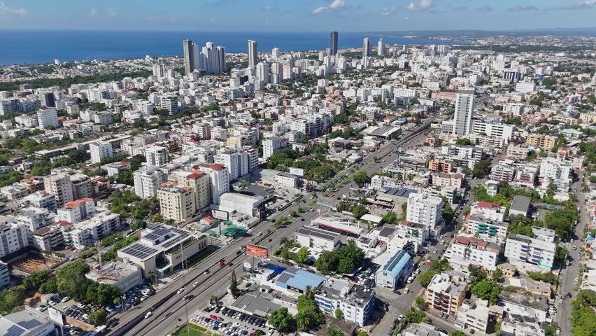 Downtown Santo Domingo aerial view overlooking the 27 de Febrero Avenue and rush hour traffic. Bird