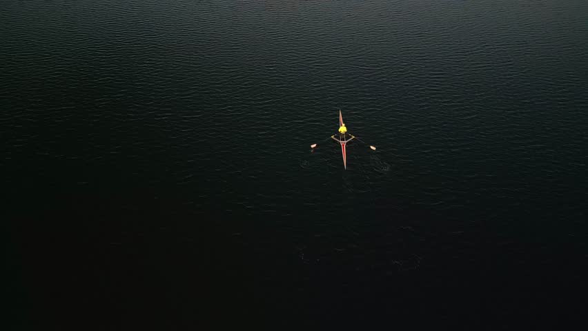 Stunning Aerial Footage Of Rowers In Eight-Oar Boats Training At Sunrise. The Tranquil Halifax Harbor And The Beautiful Golden Sunrise Provide A Serene Environment For These Young Athletes.