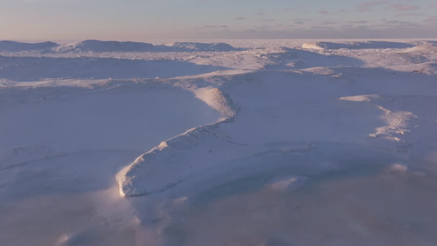 Frozen Lake Huron landscape, vast snow-covered terrain with icy blue hues