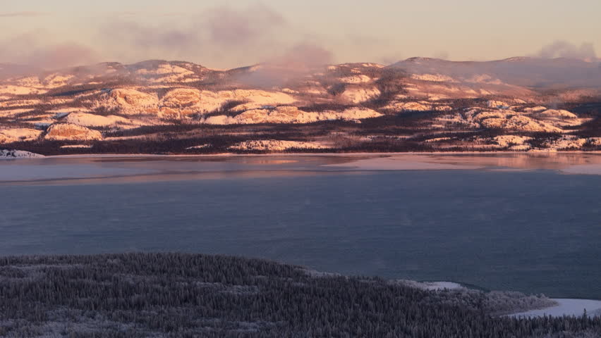 Clouds Over Mountains At Lake Laberge During Sunset In Yukon Territory, Canada. Wide Shot