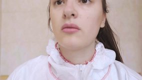 Before starting work in the hospital, medical worker in protective suit puts on a mask for maximum protection during flu epidemic. - Powered by Shutterstock - Get 15% off with code: PIKWIZARD15