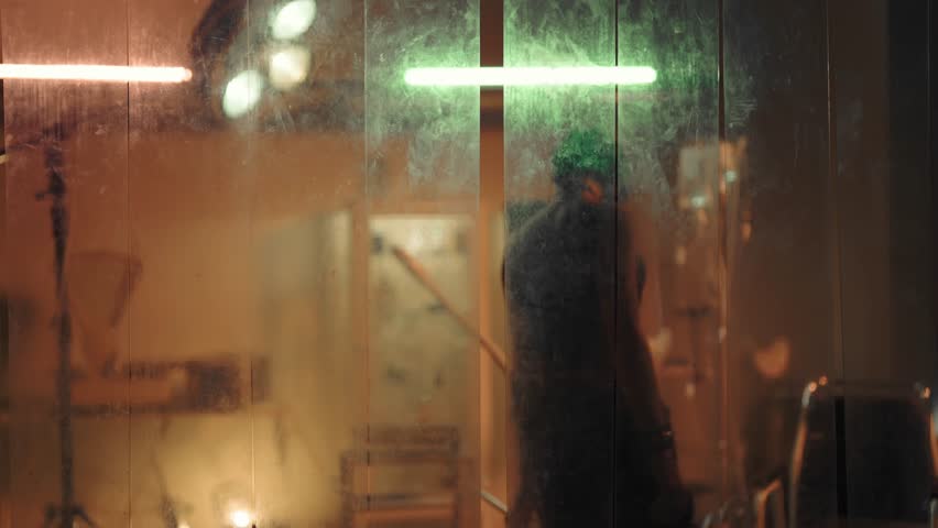 Female silhouette in old clinic, depressive woman with mental disease walking. Scary movie and horror, lair of maniac, abandonment and loneliness, sad slender lady in black clothes moving slowly