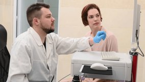 Male doctor examines neoplasms or moles on the woman patient's skin - using special apparatus for dermatoscopy digital dermoscope. Prevention of melanoma and skin cancer. World Cancer Day	 - Powered by Shutterstock - Get 15% off with code: PIKWIZARD15