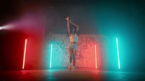 Hip-hop, breakdance and reggaeton dance style, beautiful African woman dancing. Talented mixed race lady rehearsing and performing trendy contemporary dance movements, slow motion, female silhouette - Powered by Shutterstock - Get 15% off with code: PIKWIZARD15