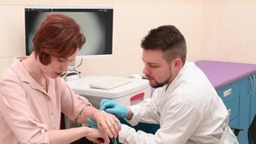 Male doctor examines neoplasms or moles on the woman patient's skin - using special apparatus for dermatoscopy digital dermoscope. Prevention of melanoma and skin cancer. World Cancer Day	 - Powered by Shutterstock - Get 15% off with code: PIKWIZARD15
