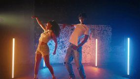 Dance and energy, portrait of couple of African American dancers in studio. Joyful pair of dance performers enjoying music in dance party, street style and contemporary choreography, medium shot - Powered by Shutterstock - Get 15% off with code: PIKWIZARD15