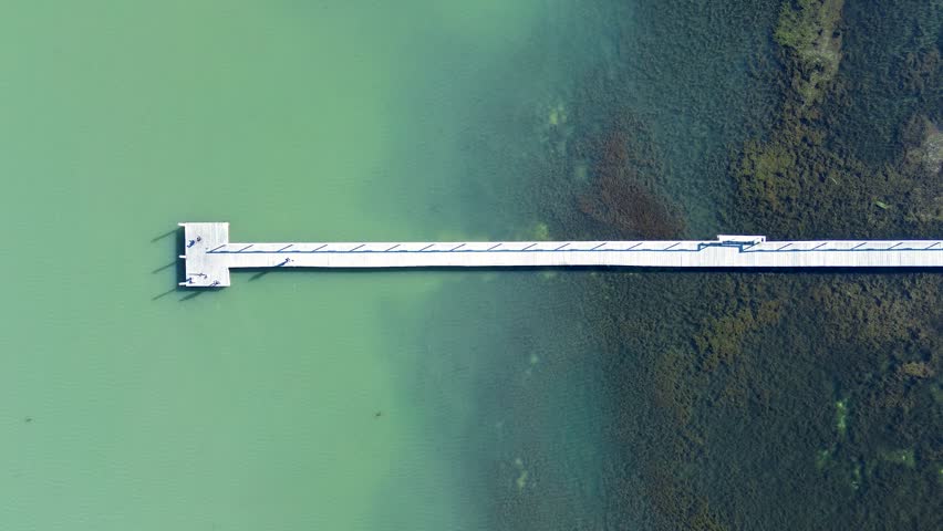 Drone aerial landscape of Long Jetty boardwalk walkway wooden timber pier fishing dock in Tuggerah Lake lagoon water catchment The Entrance Central Coast Australia travel tourism infrastructure