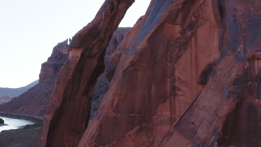 Drone fly close to Jug Handle Arch, natural sandstone geological wonder in Utah USA below sunshine
