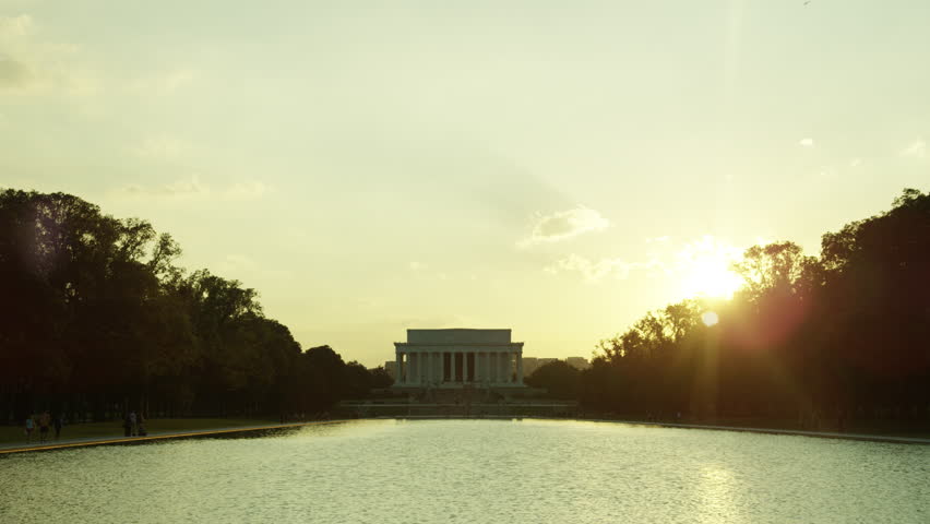 White House in Washington DC with American flag waving in the wind.