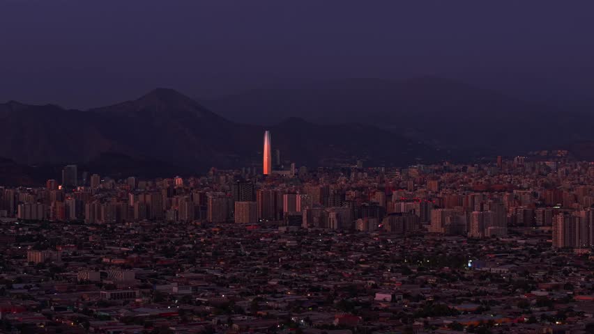 City of Santiago, Chile, surrounded by mountains and tall buildings in contrast to low-cost housing and poor neighborhoods. Social inequality