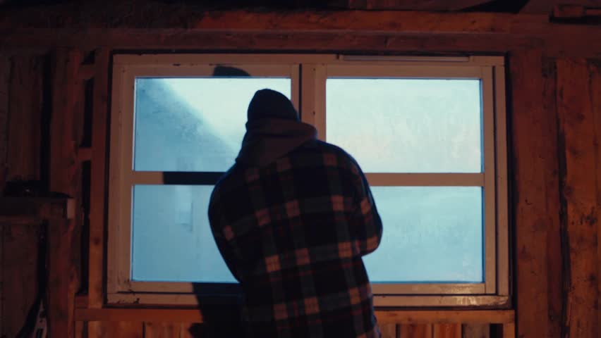 Back View Of Man In Barnhouse Opening Windows To Reveal Winter Scenery Outside. medium shot