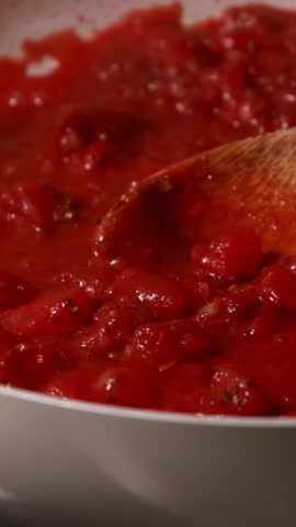  red tomato sauce simmering in a white pan
