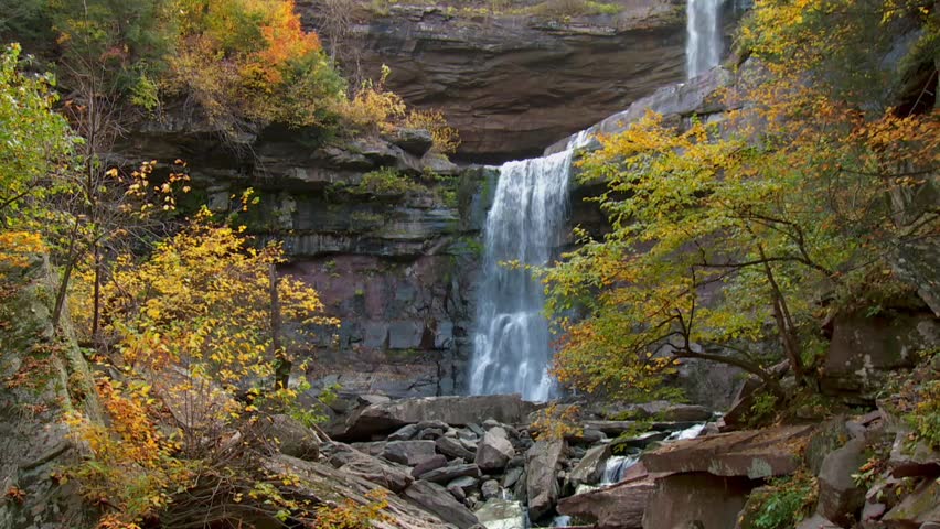 Kaaterskill Falls cascades amid autumn foliage in Catskill Park, New York, USA.