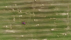 Vehicle driving circular maneuvers on rural farm field with scattered hay bales - Powered by Shutterstock - Get 15% off with code: PIKWIZARD15