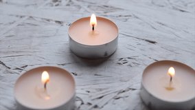 Burning candles create a warm and calming atmosphere. One candle is extinguished, releasing a trail of smoke. Scene highlights meditation, psychology, and inner peace. - Powered by Shutterstock - Get 15% off with code: PIKWIZARD15