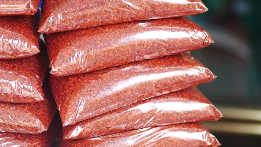 Carefully piled red spice bags intended for various culinary uses and recipes