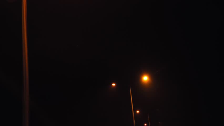 Night Drive on Mountain Highway City Lights and Street Lamps Illuminating the Road