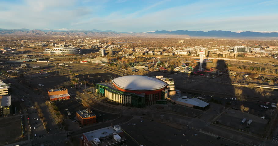 Aerial View Of Ball Arena, Island Kingdom Water Park, And Empower Field At Mile High Stadium In Denver, Colorado, USA. descending approach