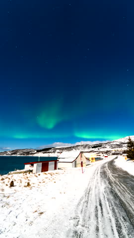 Vertical View Of Aurora Lights Shined Above Rural Fishing Village In Norway. Timelapse