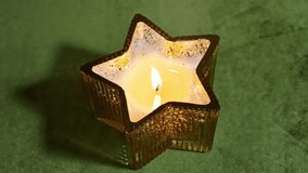 Golden candlelight flickers in glass star holder, creating cozy holiday ambiance - Powered by Shutterstock - Get 15% off with code: PIKWIZARD15