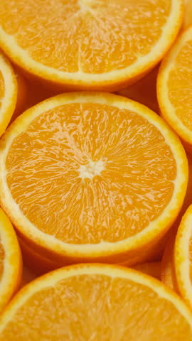 Slices orange fruit in plate, rotation
