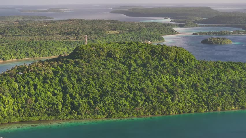 Mt Talau and telecommunication tower, lush green tropical island archipelago, Vava'u, Tonga. Drone panoramic