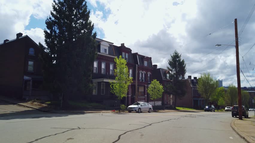 PITTSBURGH - April 14, 2019 - A view driving through homes and businesses in the Old Allegheny Rows Historic District of Pittsburgh, Pennsylvania.  	