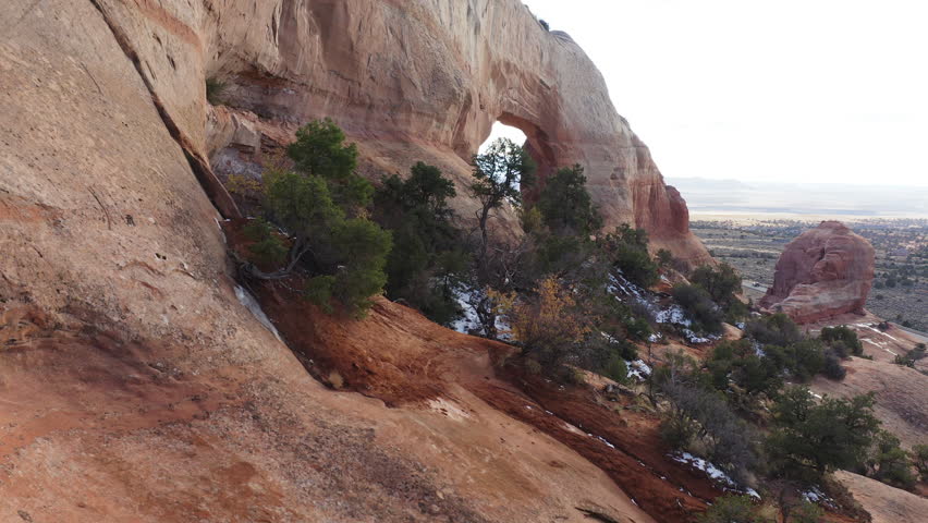 Drone fly close to Wilson Arch, Arches Natural geological Park in Utah USA, American rugged cliff formations