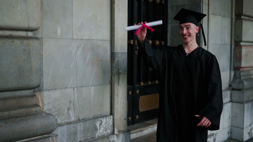 Happy college graduates celebrating with hugs and diplomas